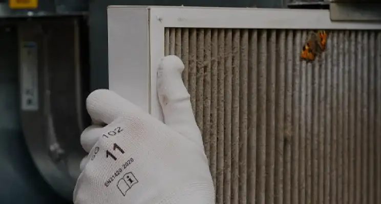 A clogged HVAC filter next to a clean replacement