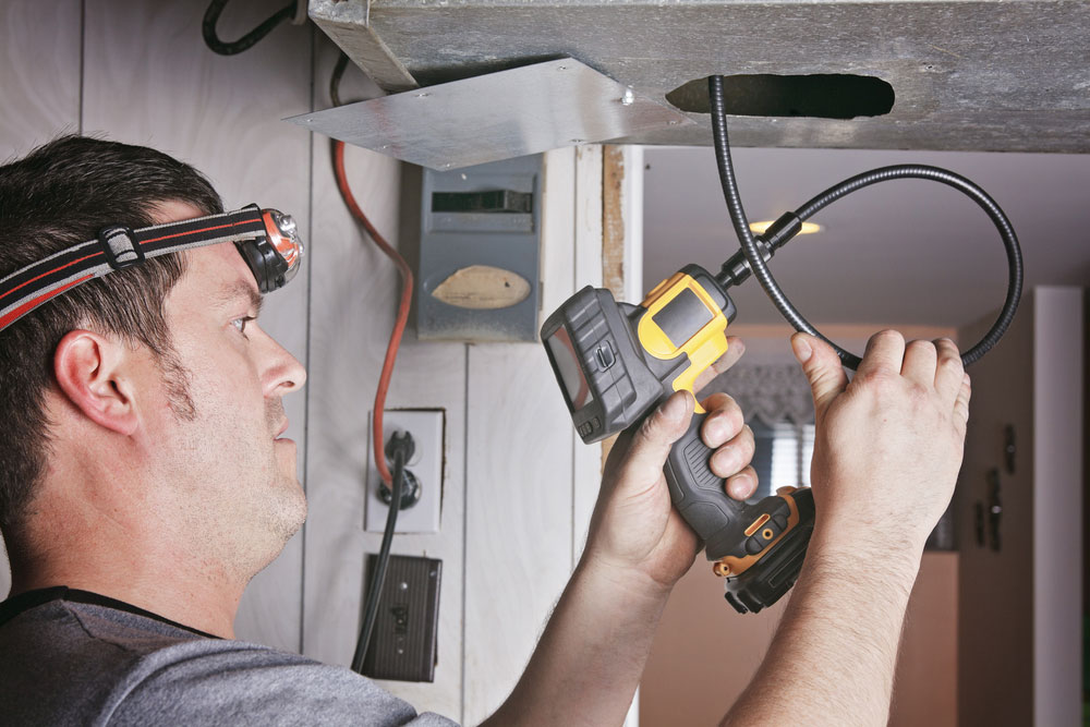 Ventilation cleaner man at work with tool