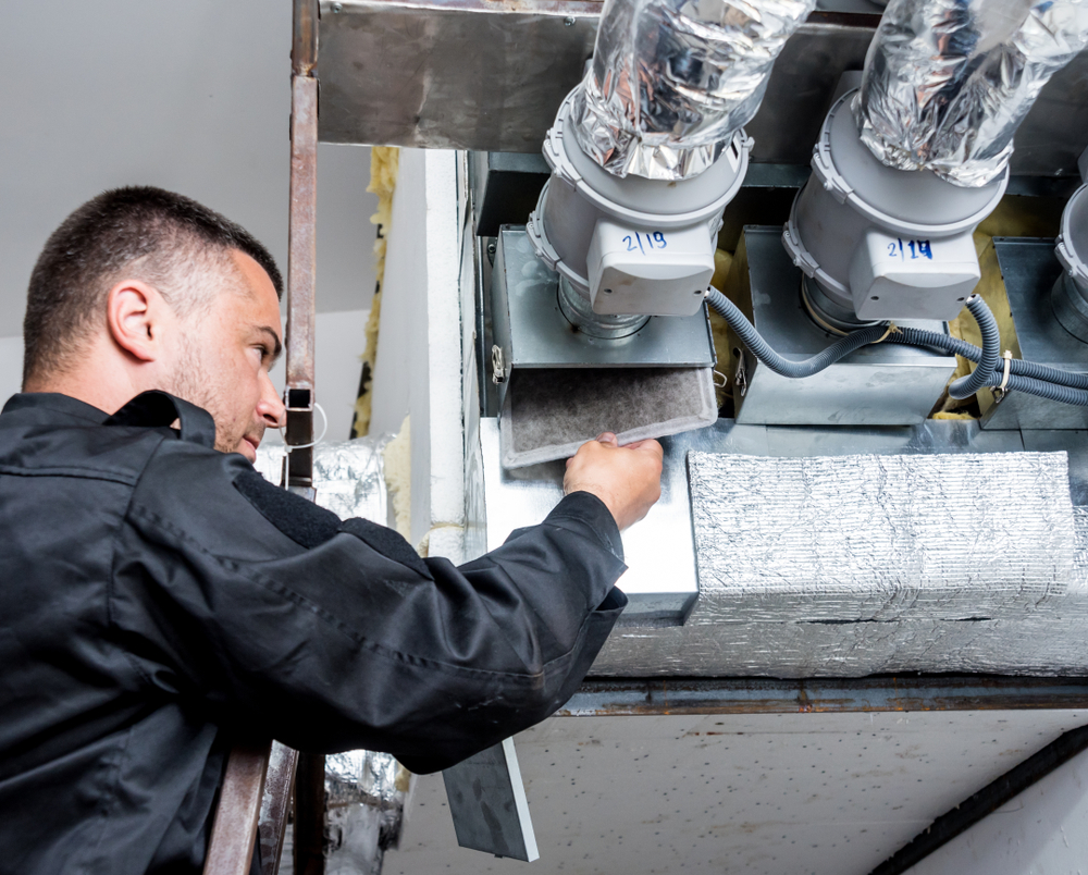 Technician looking for air duct cleaning